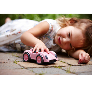 Girl playing with Pink Race Car